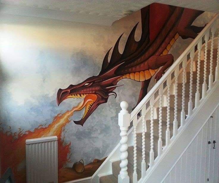 a staircase painted with a dragon on the wall and fire coming out of its mouth