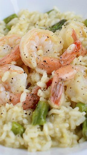 shrimp and asparagus riso with rice in a white bowl on a table