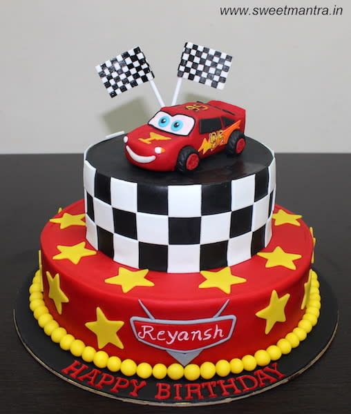 a red and black cake with cars on it