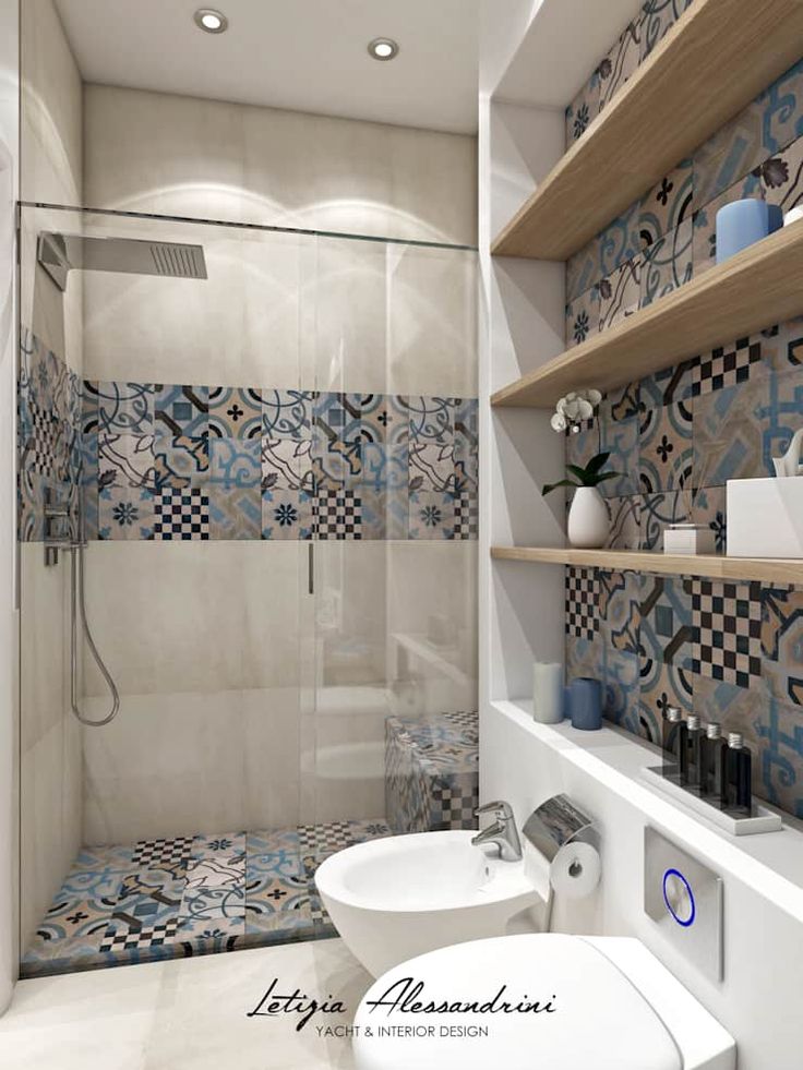 a bathroom with blue and white tiles on the walls, shelves above the toilet and sink