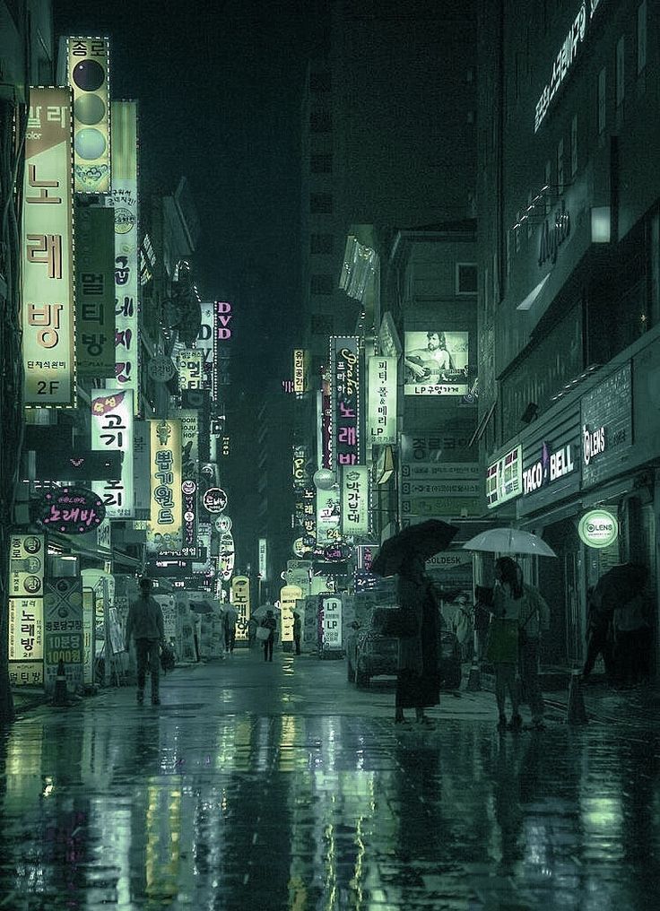 people with umbrellas are walking in the rain on a city street at night time