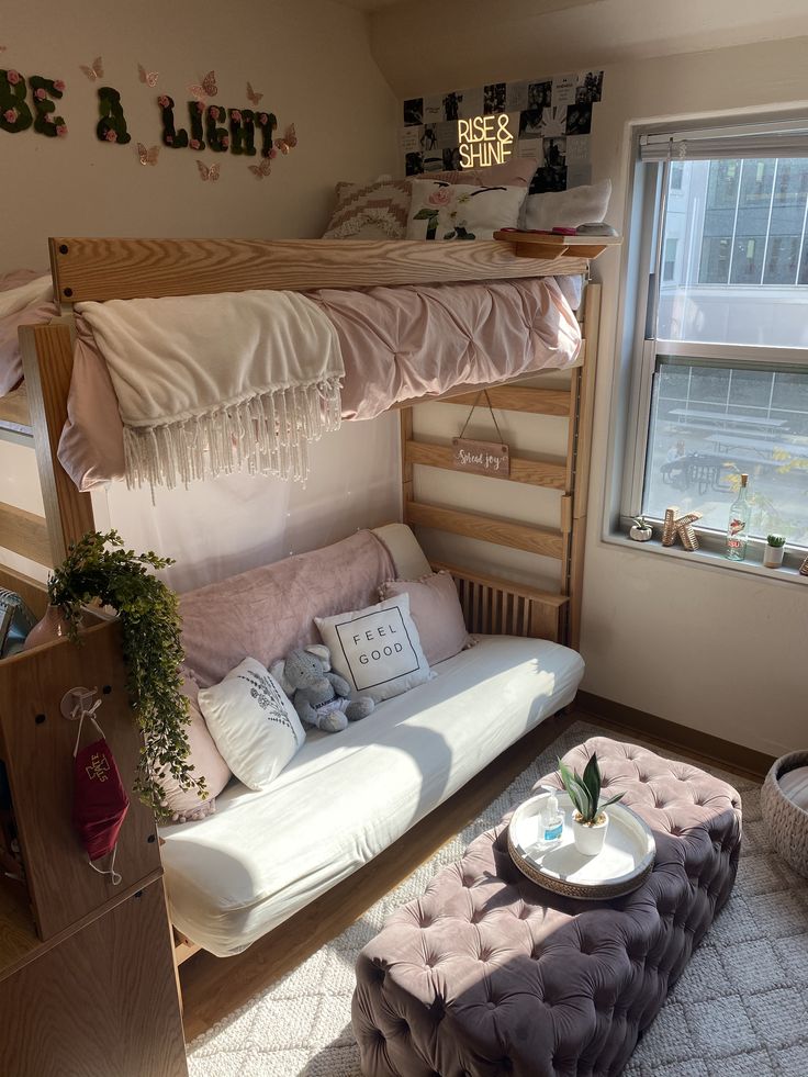 a loft bed with a futon underneath it in a living room next to a window