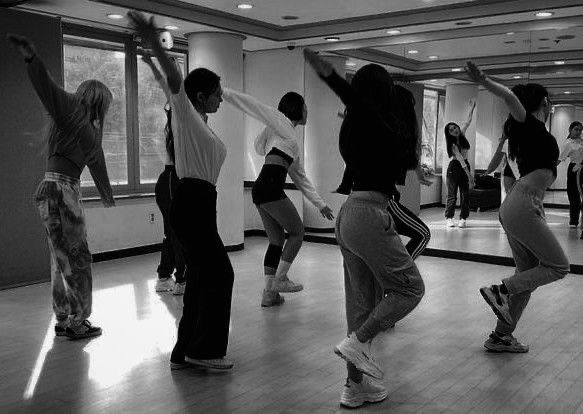 a group of young people dancing in a dance studio