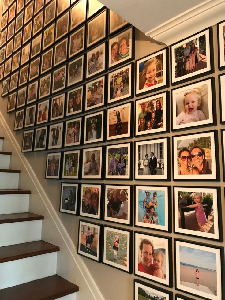 a staircase with many pictures on the wall