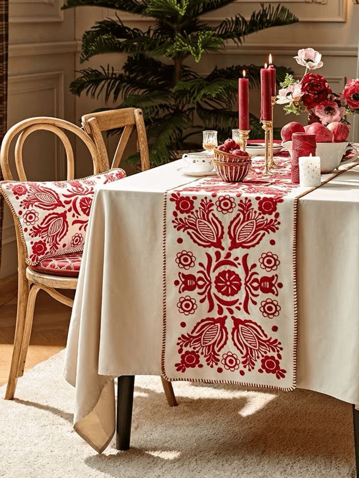 a dining room table with red and white linens