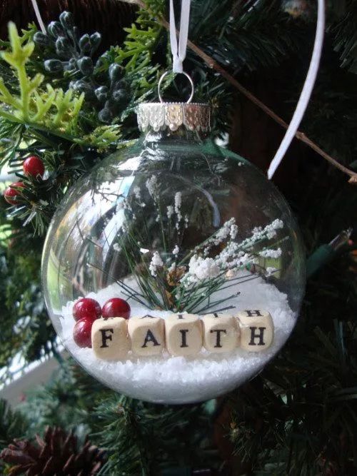 a glass ornament with the word faith in it