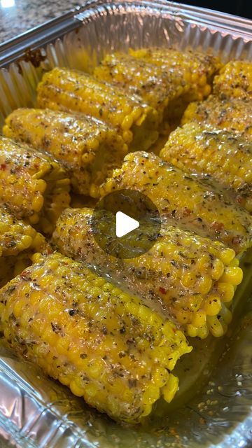 corn on the cob with seasoning in a foil container