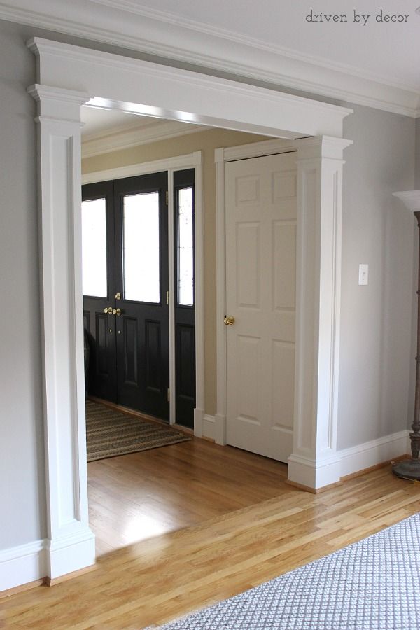 an empty living room with hard wood flooring and white trim on the door way