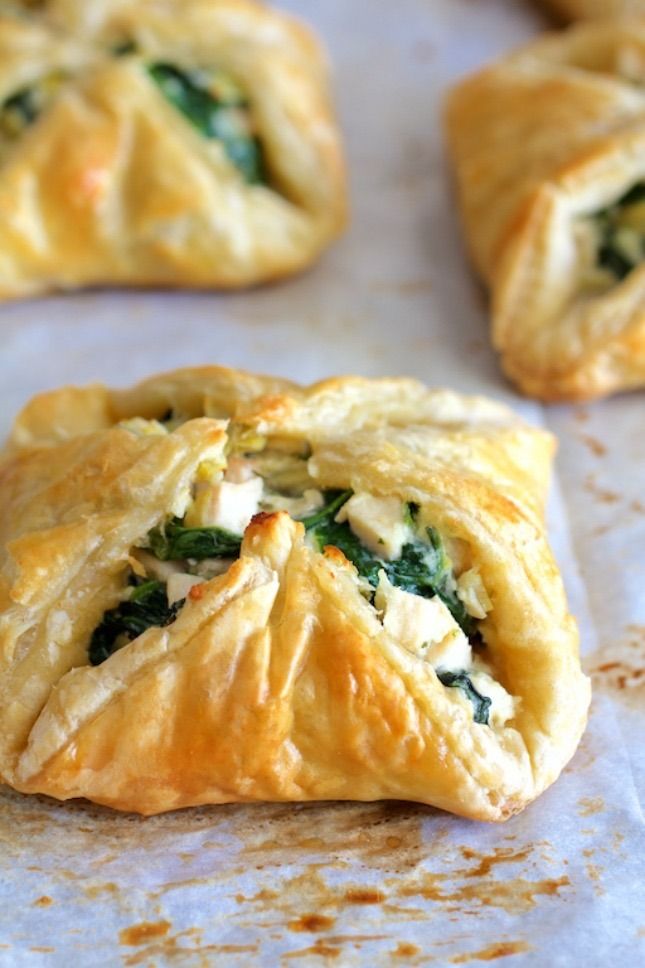 spinach and cheese pastries on a baking sheet