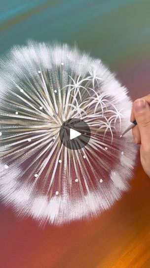 a hand holding a pen drawing a dandelion in the air with it's petals