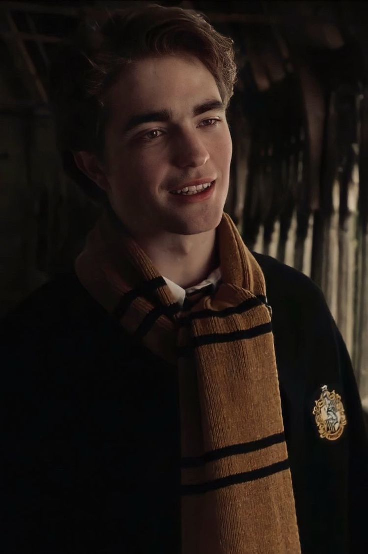 a young man wearing a harry potter scarf