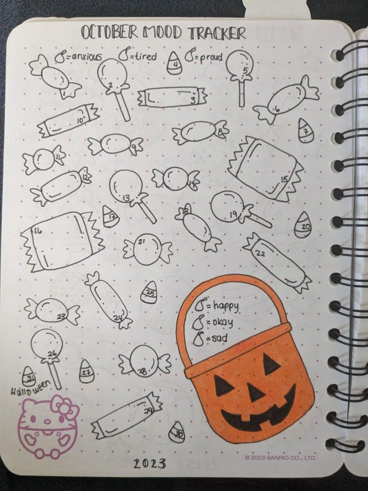 an open notebook with halloween doodles on the page and pumpkins in the background