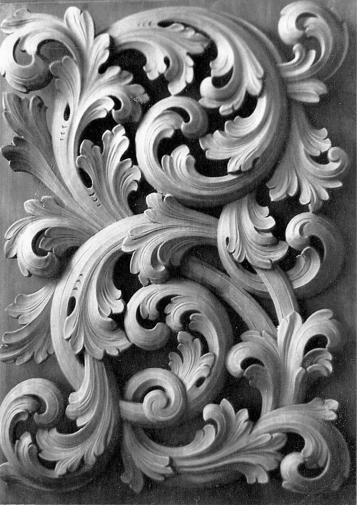 an intricately carved design on the side of a building in black and white photo