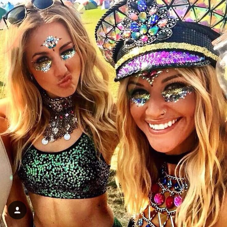 two beautiful women with face paint posing for the camera