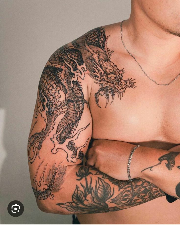 a man with tattoos on his arm and chest