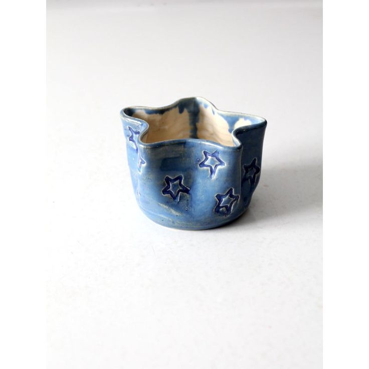 a blue and white ceramic bowl with stars on it