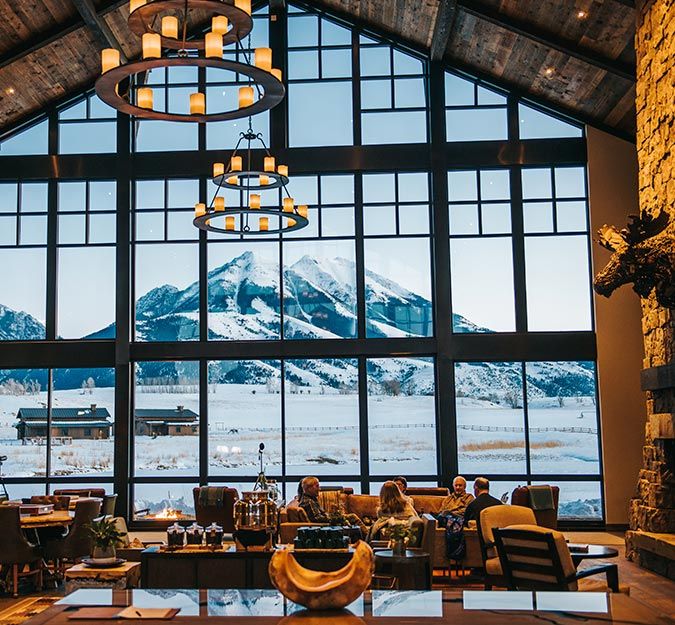 a restaurant with large windows overlooking the mountains