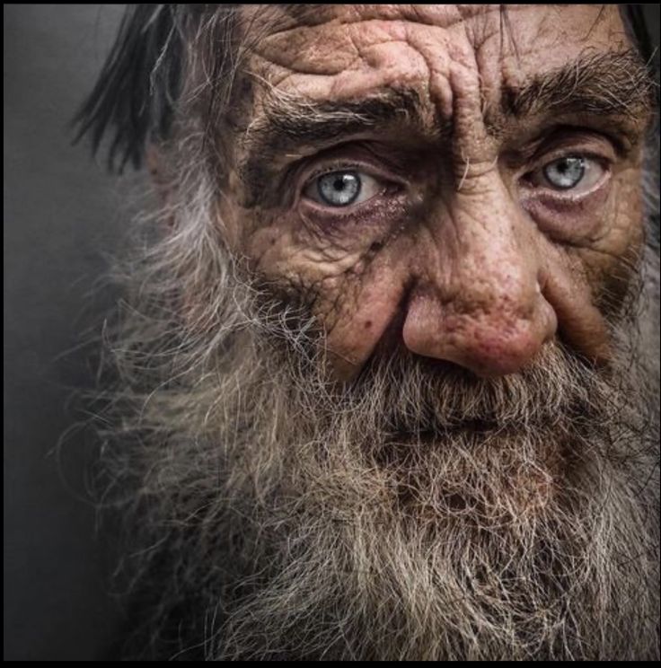 an old man with long hair and blue eyes