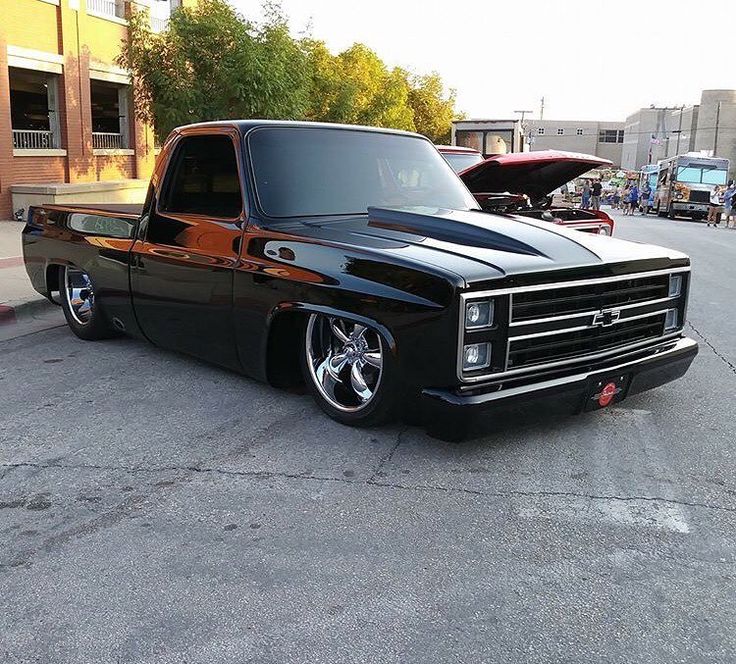 a black pickup truck parked on the street