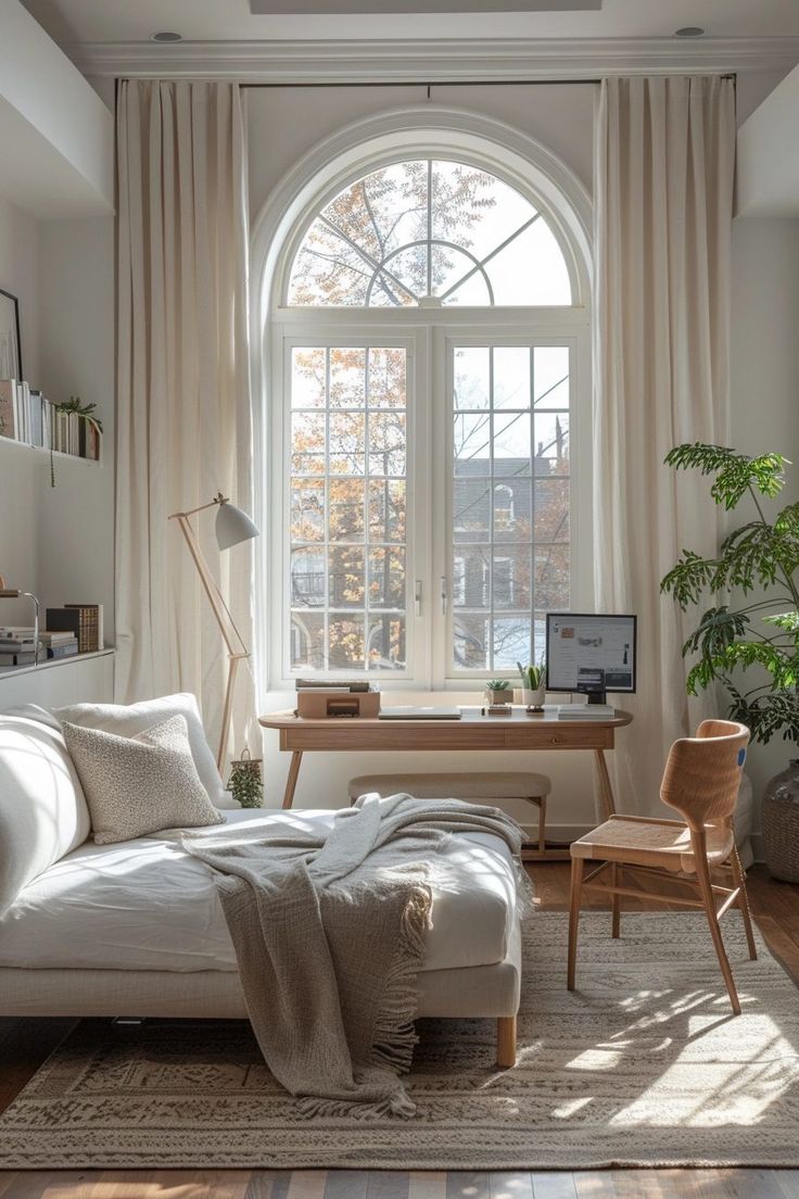 a living room filled with furniture and a large window