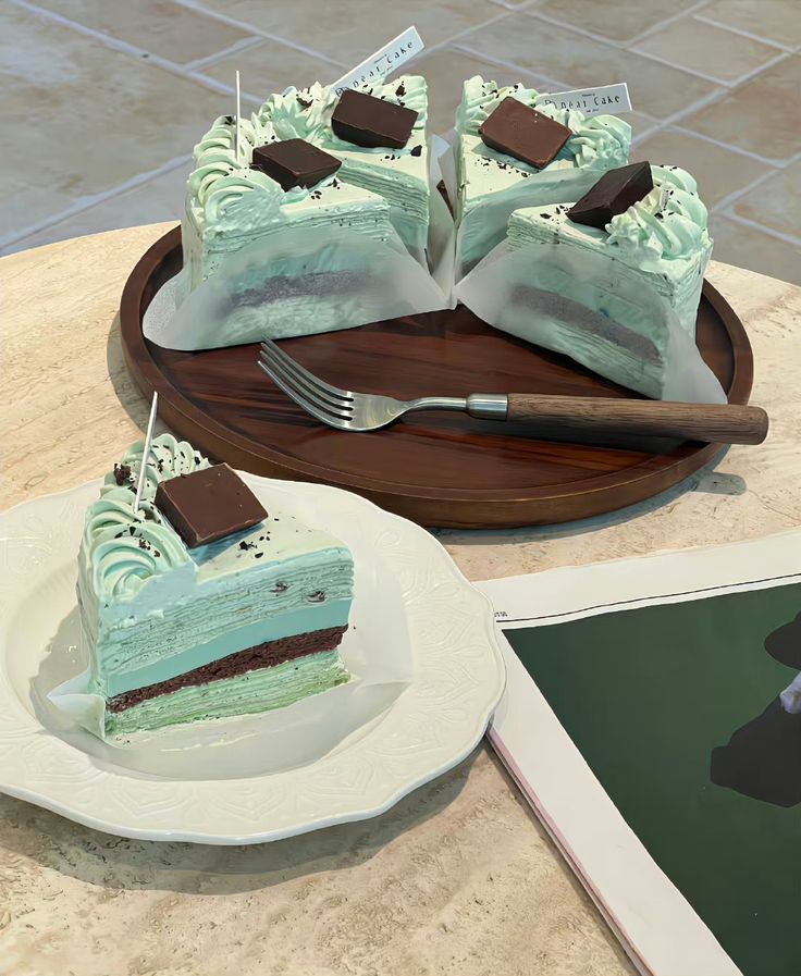 two pieces of cake sitting on top of a plate next to a knife and fork