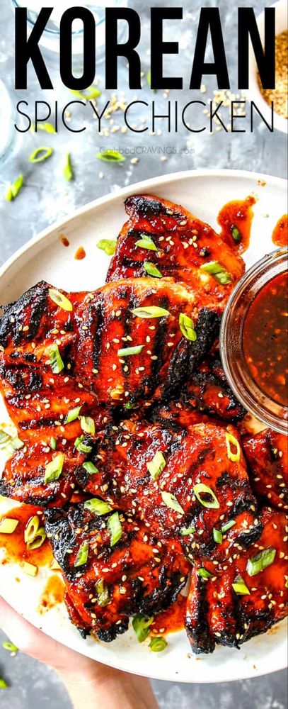 korean spicy chicken on a plate with dipping sauce