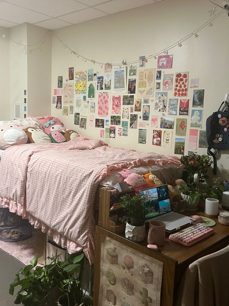 a bed room with a neatly made bed and lots of pictures hanging on the wall