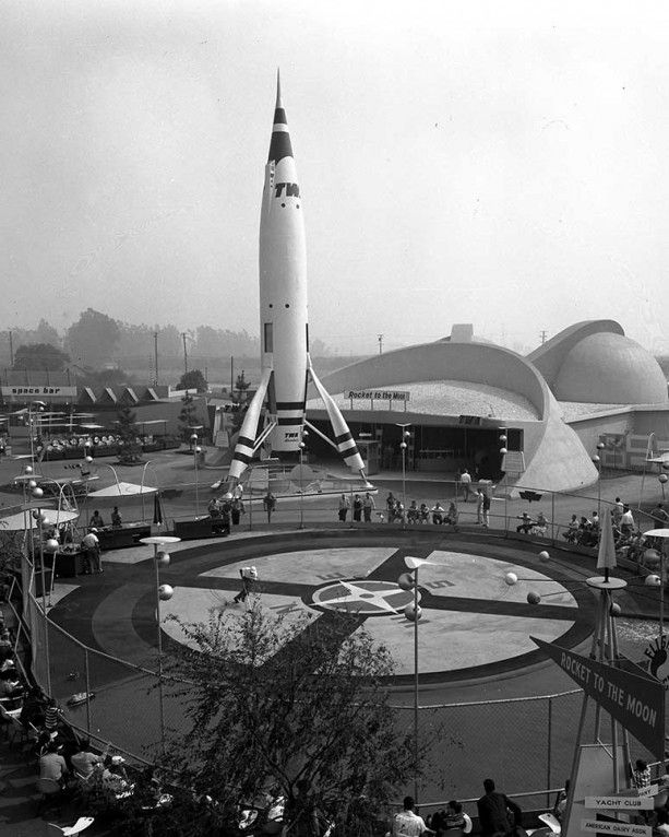 an old black and white photo of a rocket on display