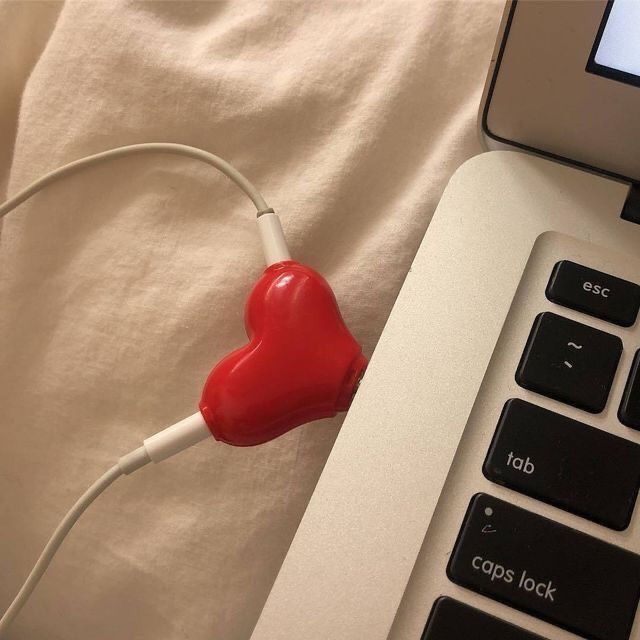 a red heart plugged into a laptop computer