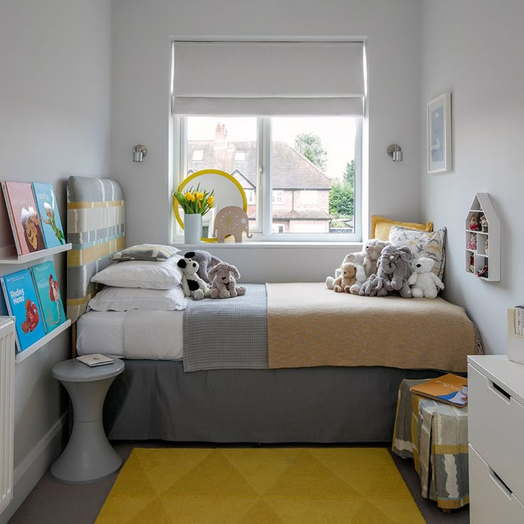 a bed room with a neatly made bed next to a window and a yellow rug