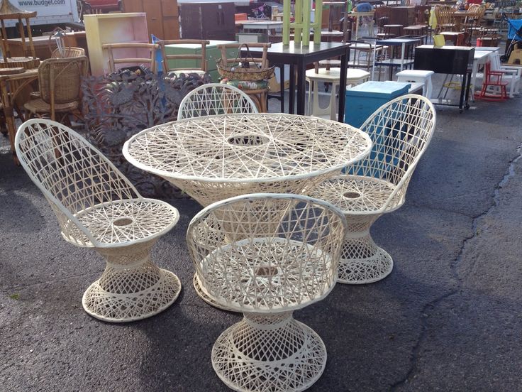 white wicker chairs and table in an outdoor market