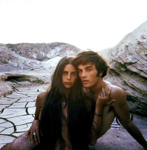 two people are posing for a photo in the desert