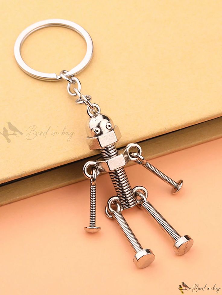 a metal keychain with two keys attached to it