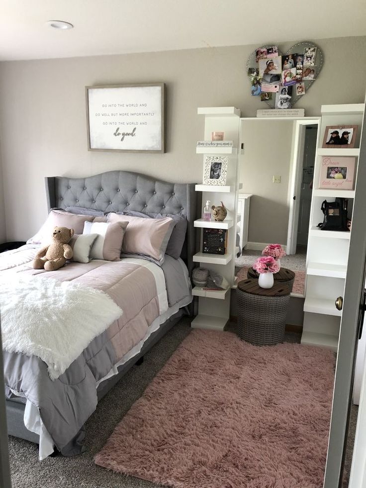 a bed room with a neatly made bed and a teddy bear sitting on the floor