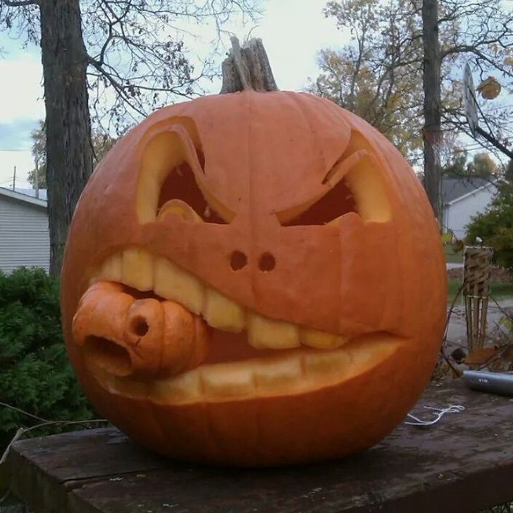 a carved pumpkin sitting on top of a wooden table