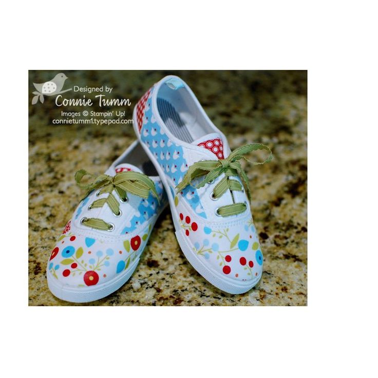 two shoes that are on the ground with polka dots and hearts painted on them,