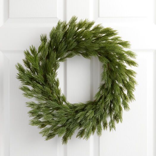 a wreath is hanging on the front door