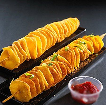 two trays filled with food sitting on top of a table next to dipping sauce