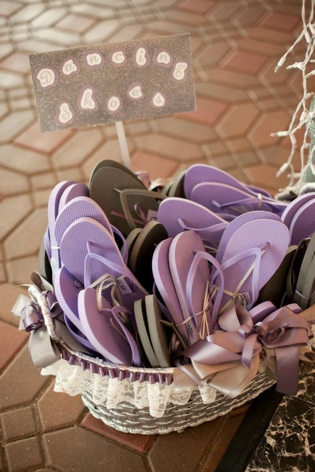 a basket filled with purple flip flops on top of a table