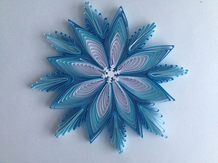 a blue and white snowflake sitting on top of a table