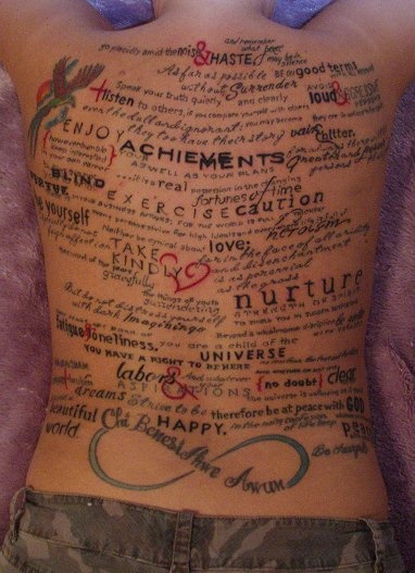 the back of a woman's stomach with words written in different languages on it