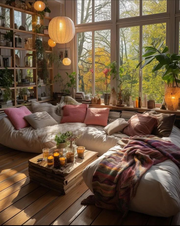 a living room filled with lots of furniture next to a large window covered in plants