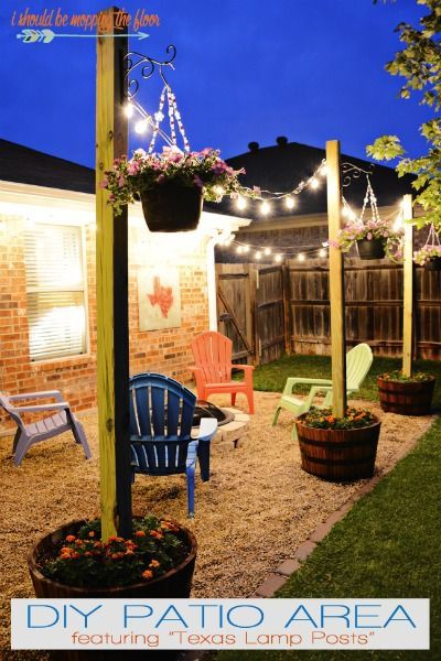 the backyard is decorated with lights and potted plants