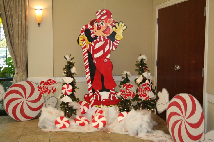 a christmas display with candy canes and an image of a man in the middle