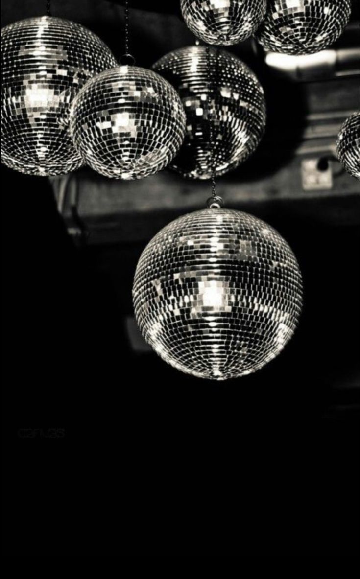 disco balls hanging from the ceiling in black and white