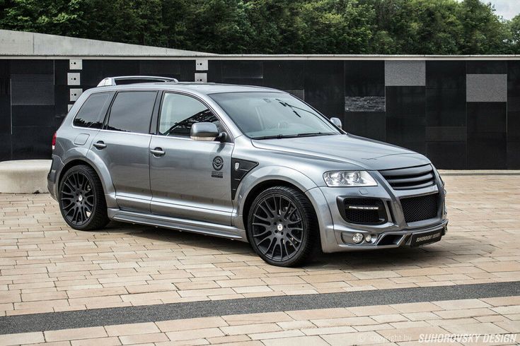 a silver suv parked in front of a building