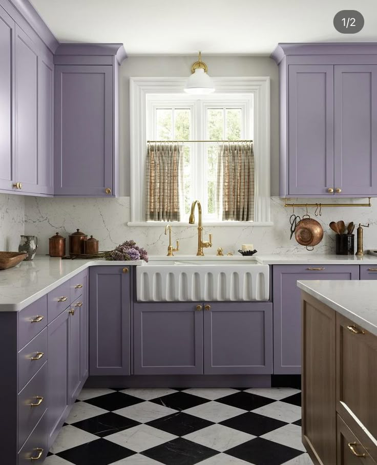 a kitchen with purple cabinets and black and white checkerboard flooring in it