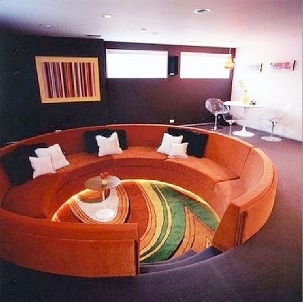 a circular couch in the middle of a living room