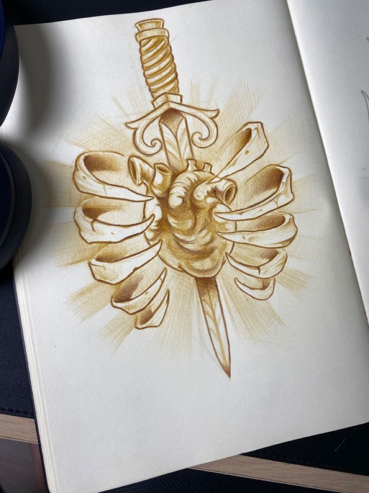 a drawing of a dagger and heart on a book