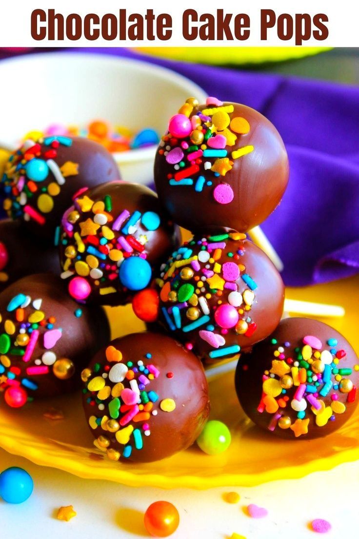 chocolate covered donuts with sprinkles on a pink and white checkered plate